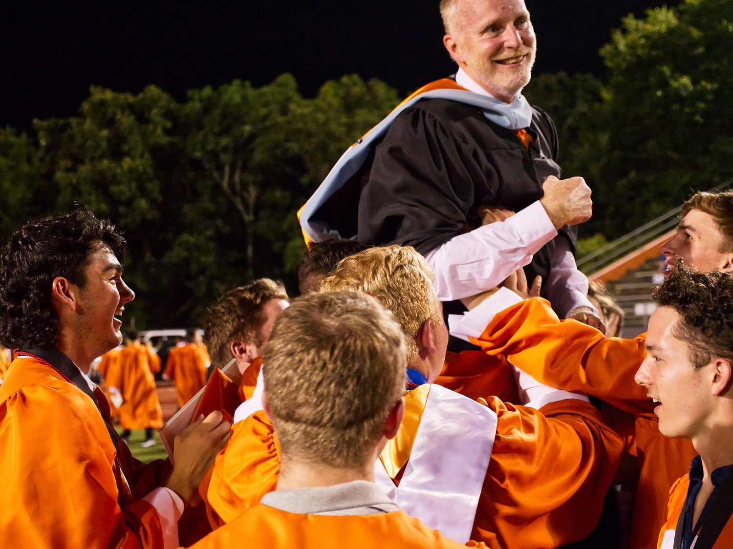 Mineola grads lift Principal David Sauer onto their shoulders following Friday’s graduation ceremony. Sauer will be moving to central administration and the Class of 2020 is his last one at MHS.